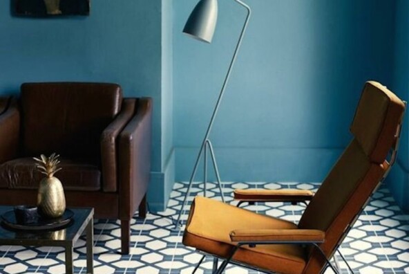 blue living room with bold tile and mid century modern lounge chair