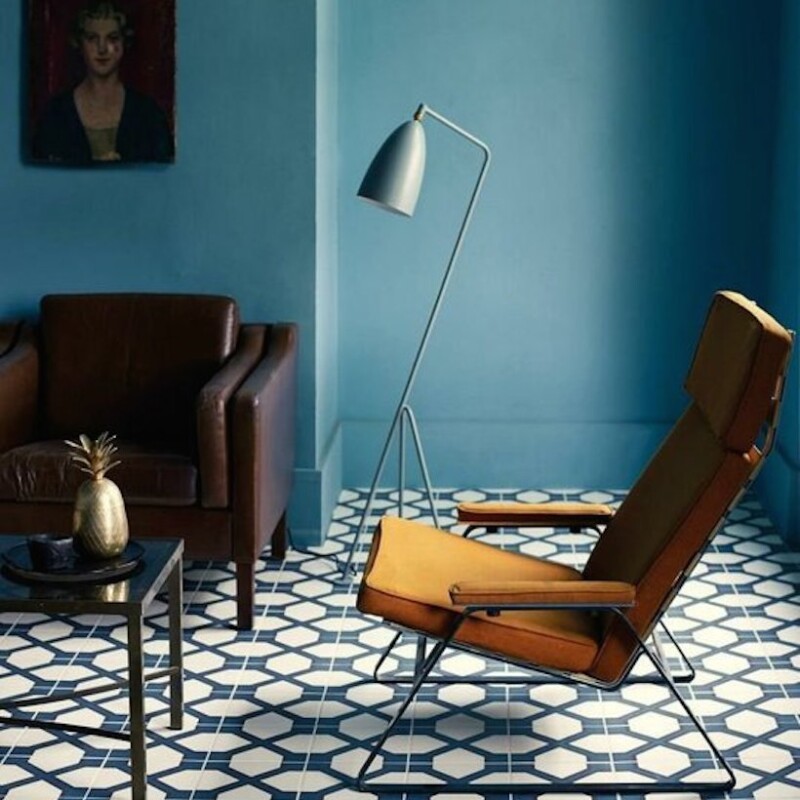 blue living room with bold tile and mid century modern lounge chair