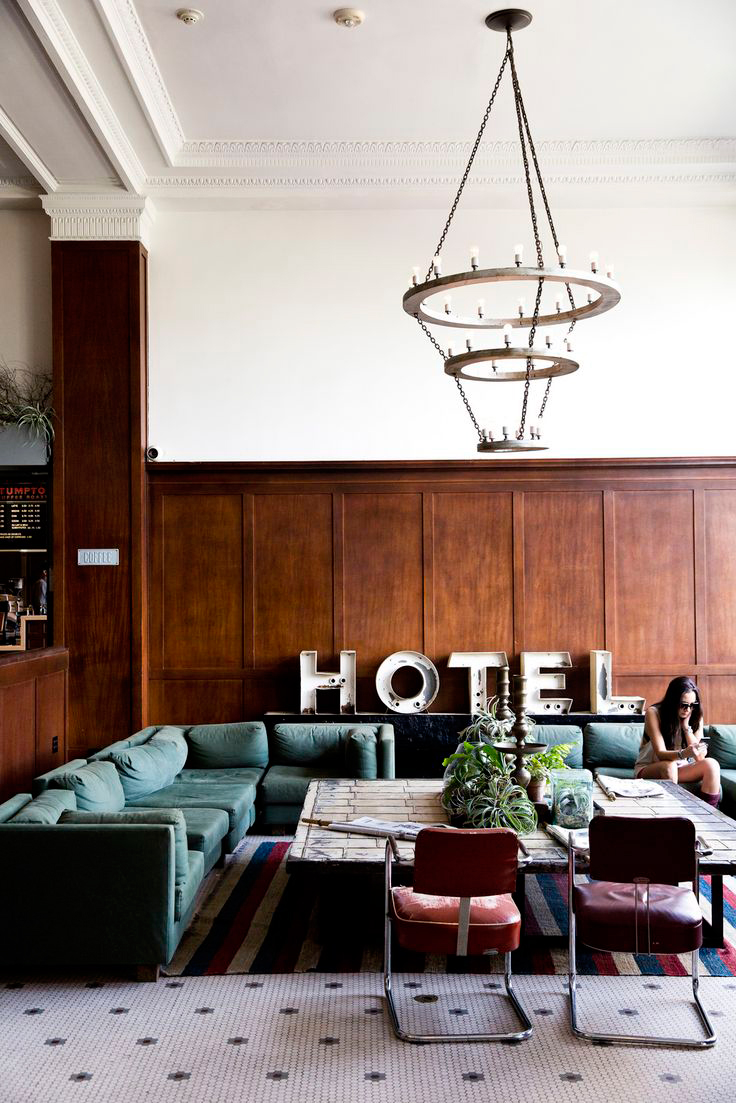 green sectional | wood paneling | Ace Hotel Portland