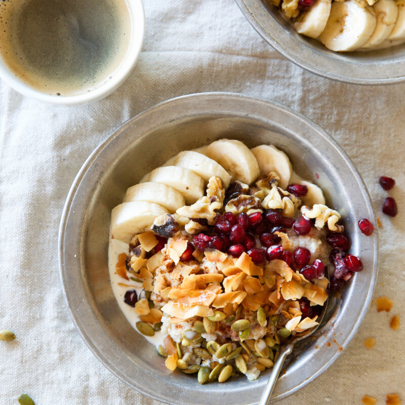 A Power Bowl to Start the Morning! Oatmeal Quinoa Breakfast Bowl Recipe with Bananas, Coconut, Pepitas, Pomegranate Seeds, Maple Syrup, & Cinnamon