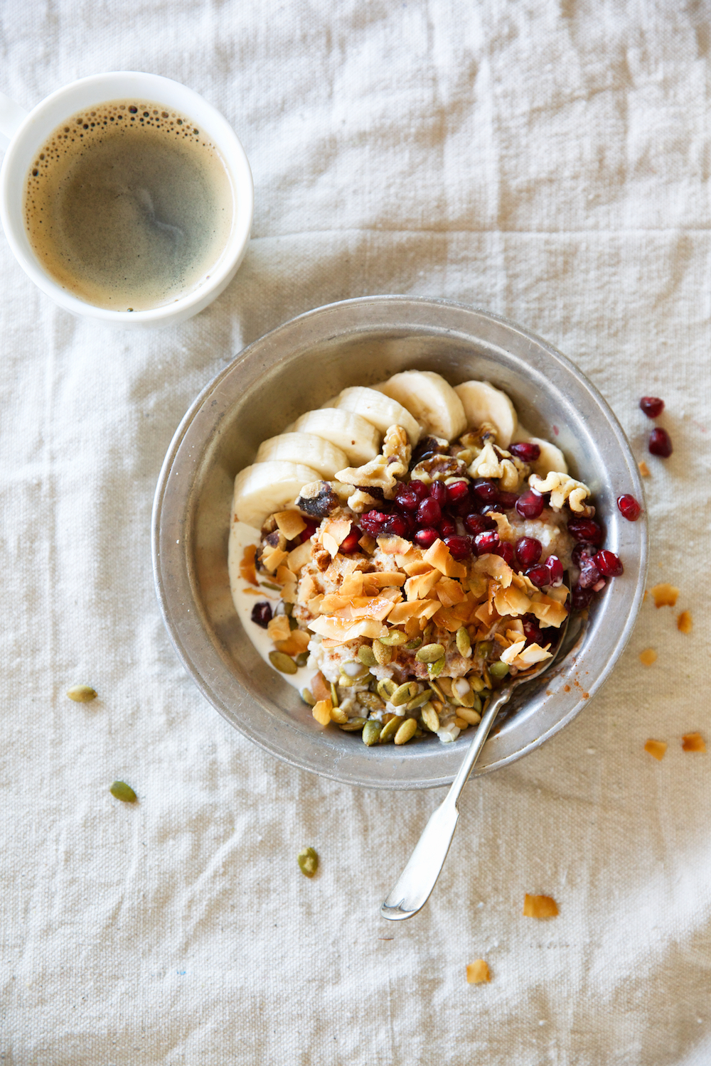 A Power Bowl to Start the Morning!  Oatmeal Quinoa Breakfast Bowl Recipe with Bananas, Coconut, Pepitas, Pomegranate Seeds, Maple Syrup, & Cinnamon_foods that help with period cramps
