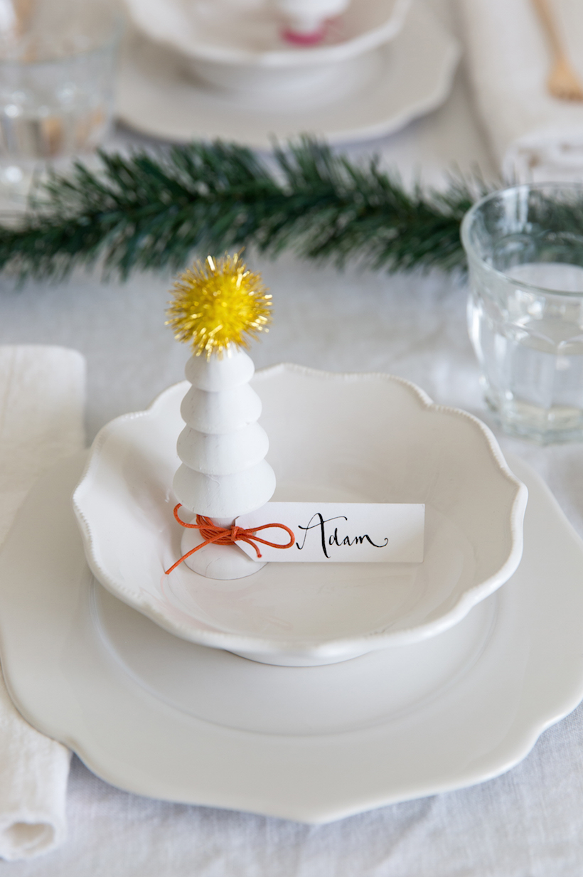 DIY place cards out of cute wooden Christmas trees. Love this for a minimalist holiday table!