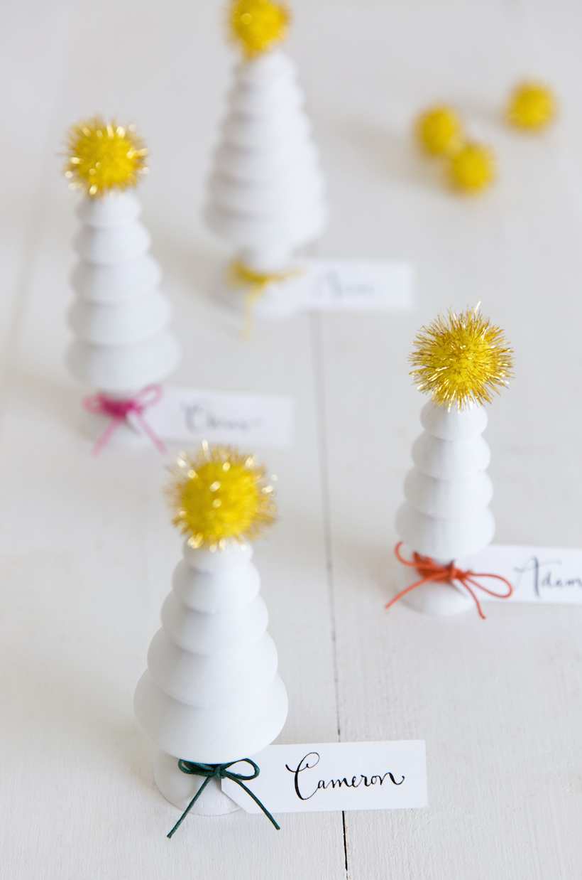 DIY place cards out of cute wooden Christmas trees. Love this for a whimsical holiday table!