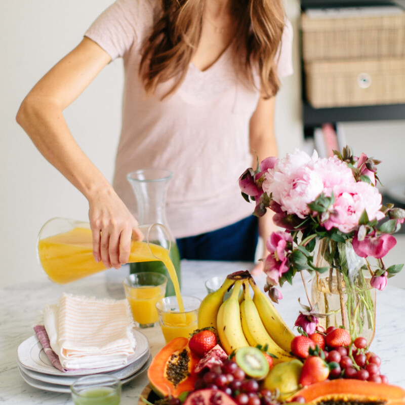 Love the idea of mixing fruits and flowers for a cute brunch tablescape.