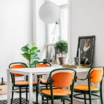 swedish dining room - love the bright pop of orange!