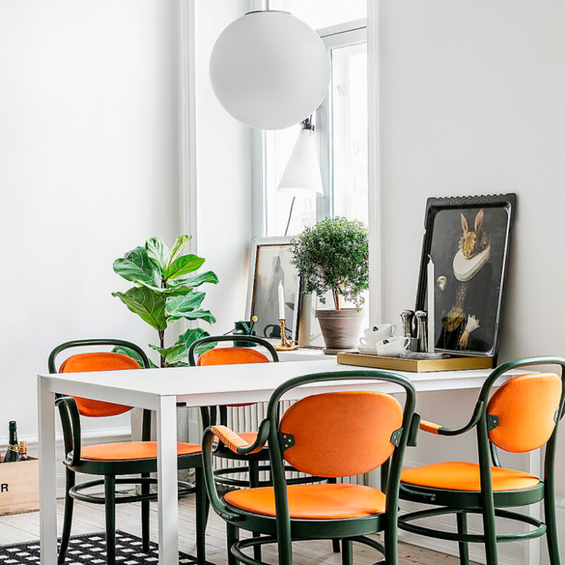 swedish dining room - love the bright pop of orange!