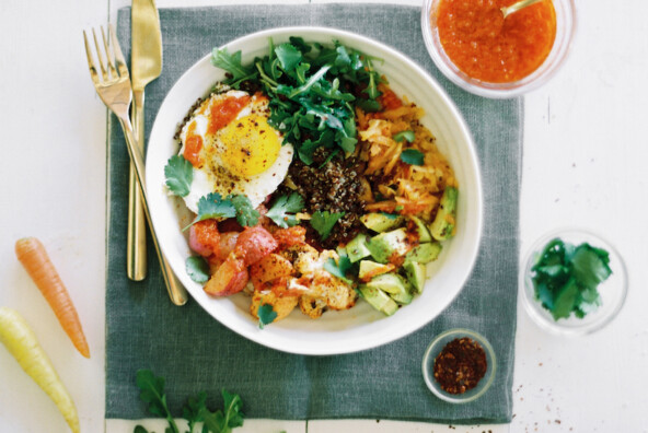 Quinoa bowl with harissa-roasted veggies, avocado, and fried egg