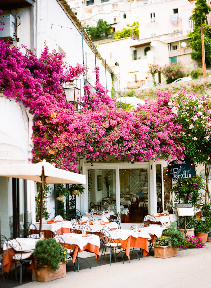 outdoor dining & pink bougainvillea in positano, italy