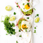 classic avocado toast with fried eggs, cilantro, & chili flakes