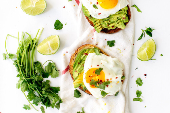 classic avocado toast with fried eggs, cilantro, & chili flakes