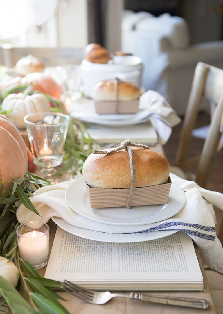 Beautiful thanksgiving table setting idea with fresh loaves of bread at each place setting - Ella Claire