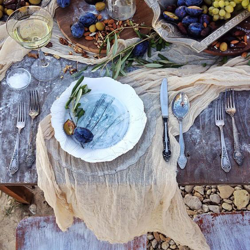 Drape a gauzy scarf across the table.