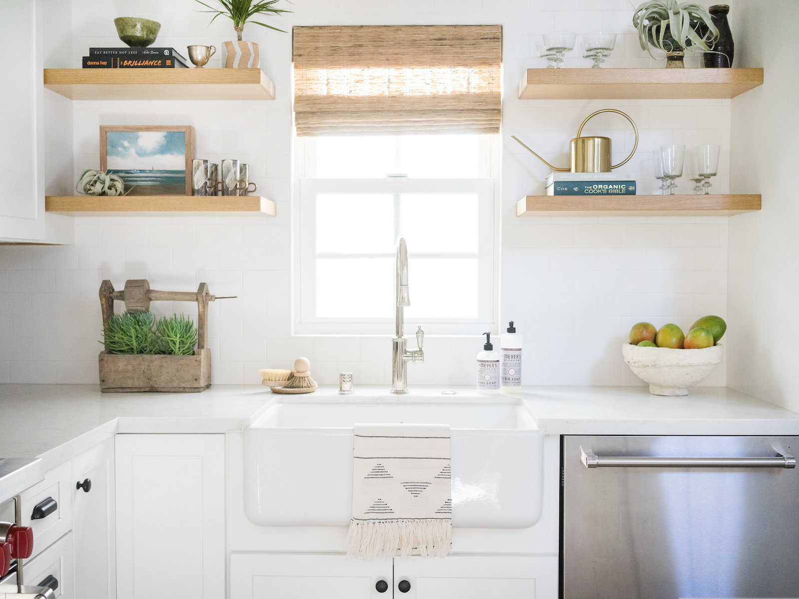 all white kitchen with floating shelves