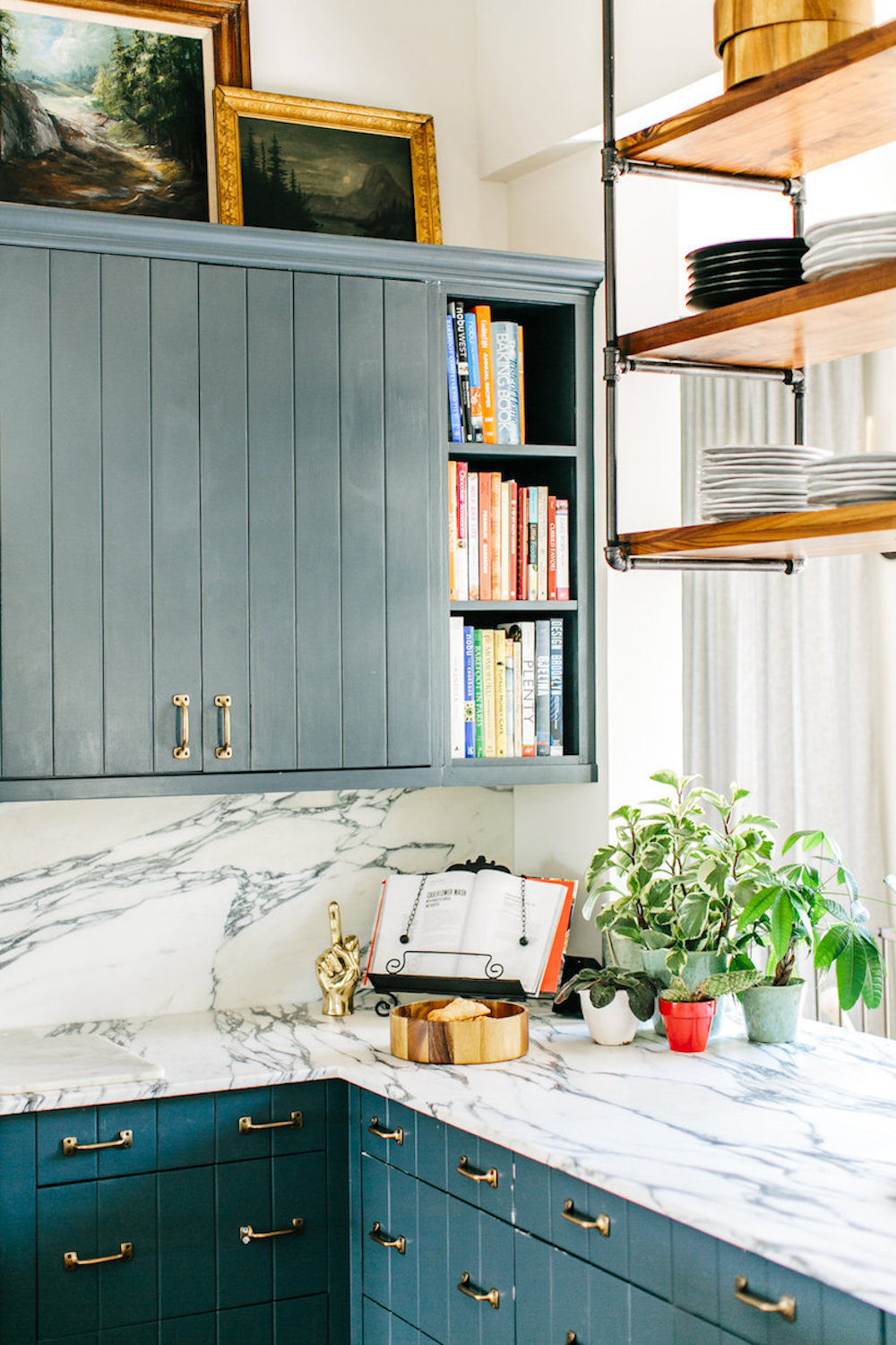 brooklyn decker's kitchen with blue cabinets and marble