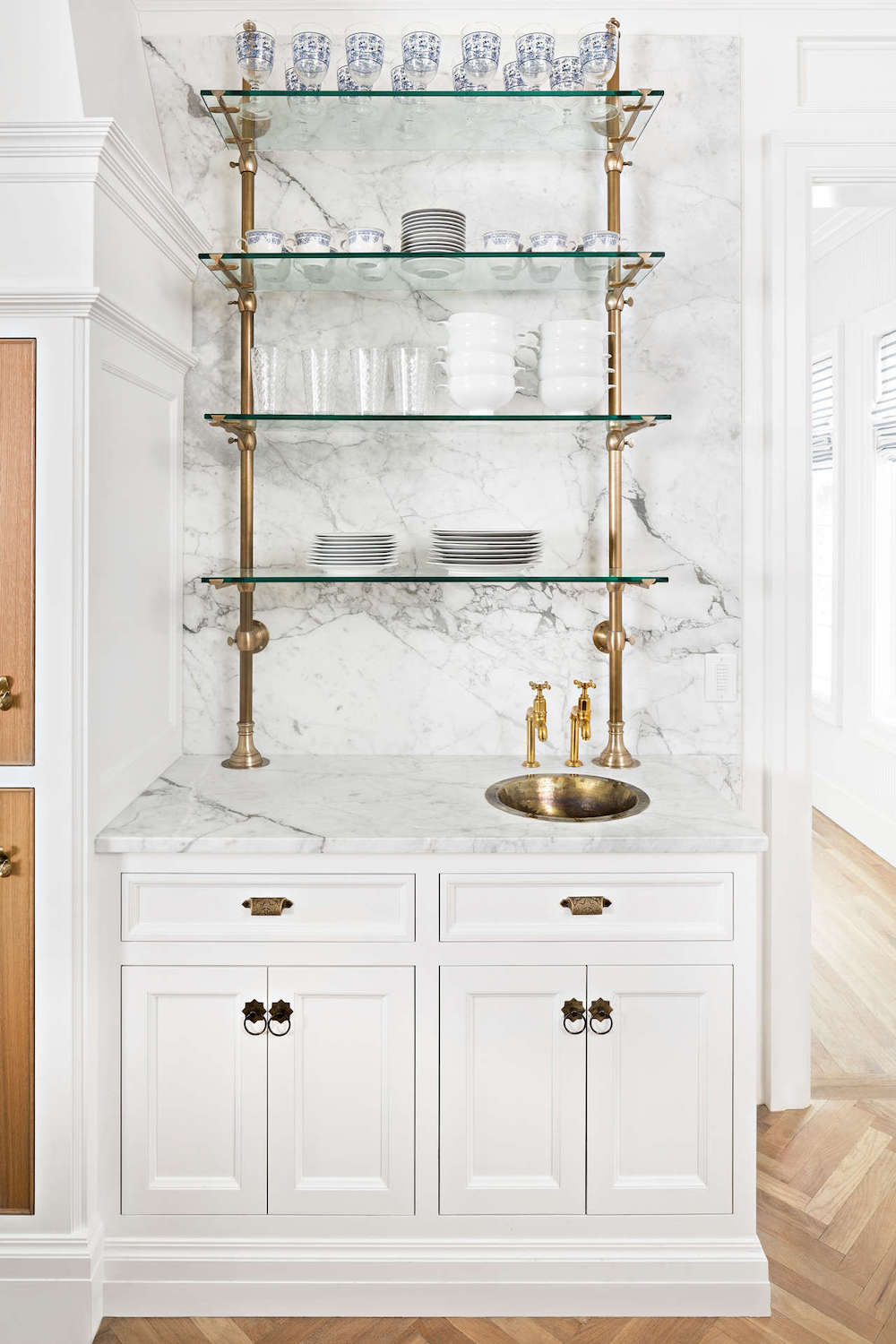 marble backsplash with glass shelves