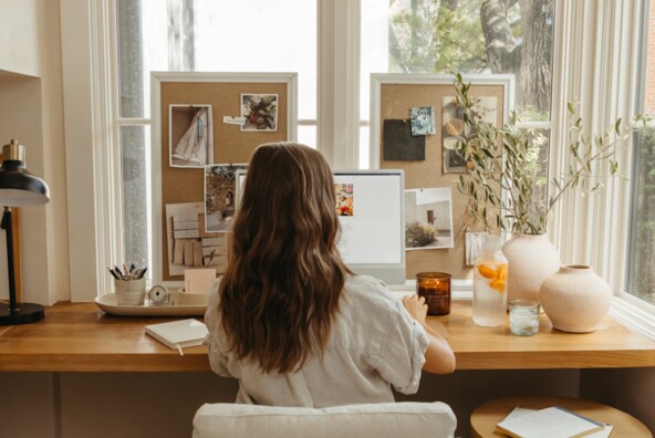 camille Styles working at desk