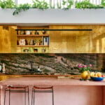 Alex Van Der Sluys's striking kitchen with stone, brass and pink