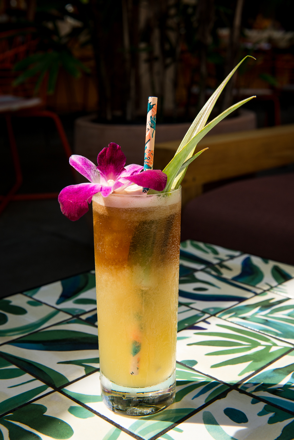 tropical cocktail with orchid garnish