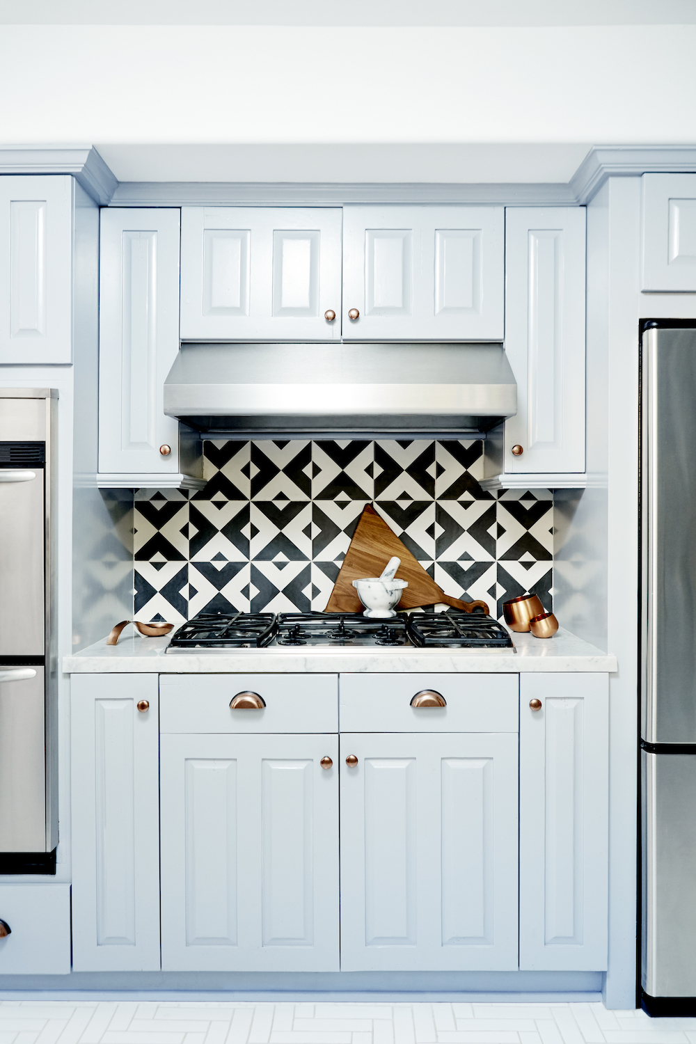 nina dobrei's fun kitchen with black and white tile backsplash and blue cabinet paint