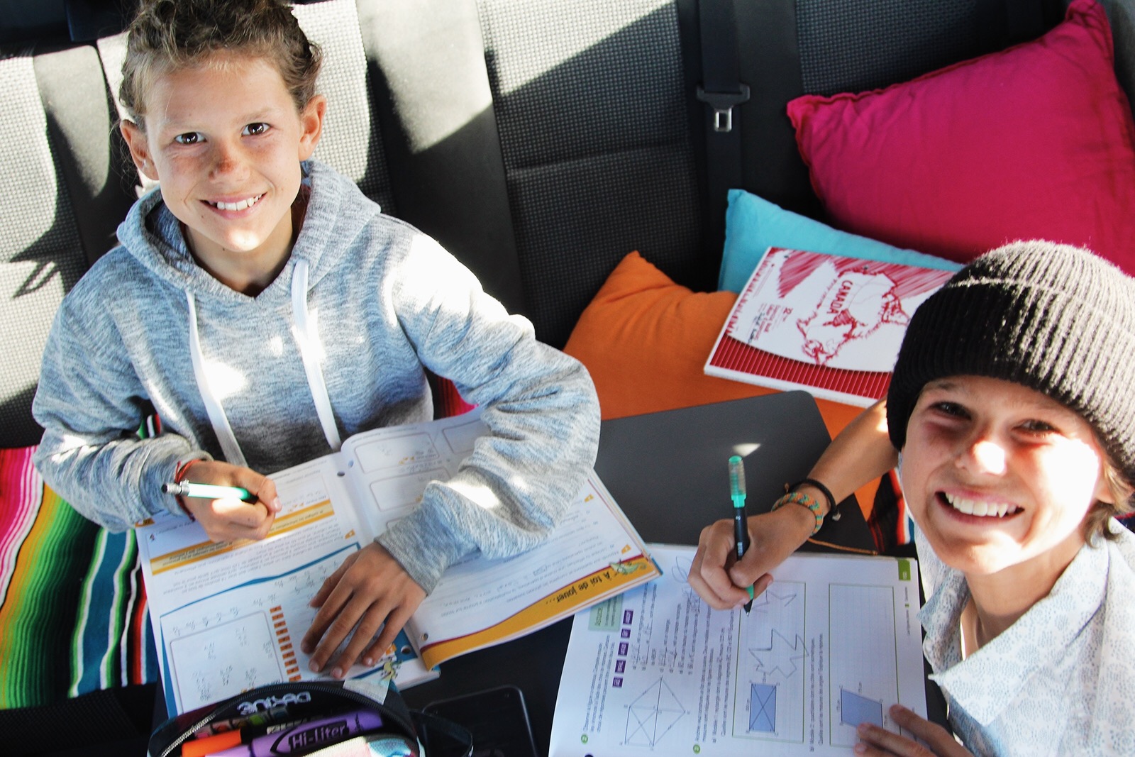 Kids doing homework on the road