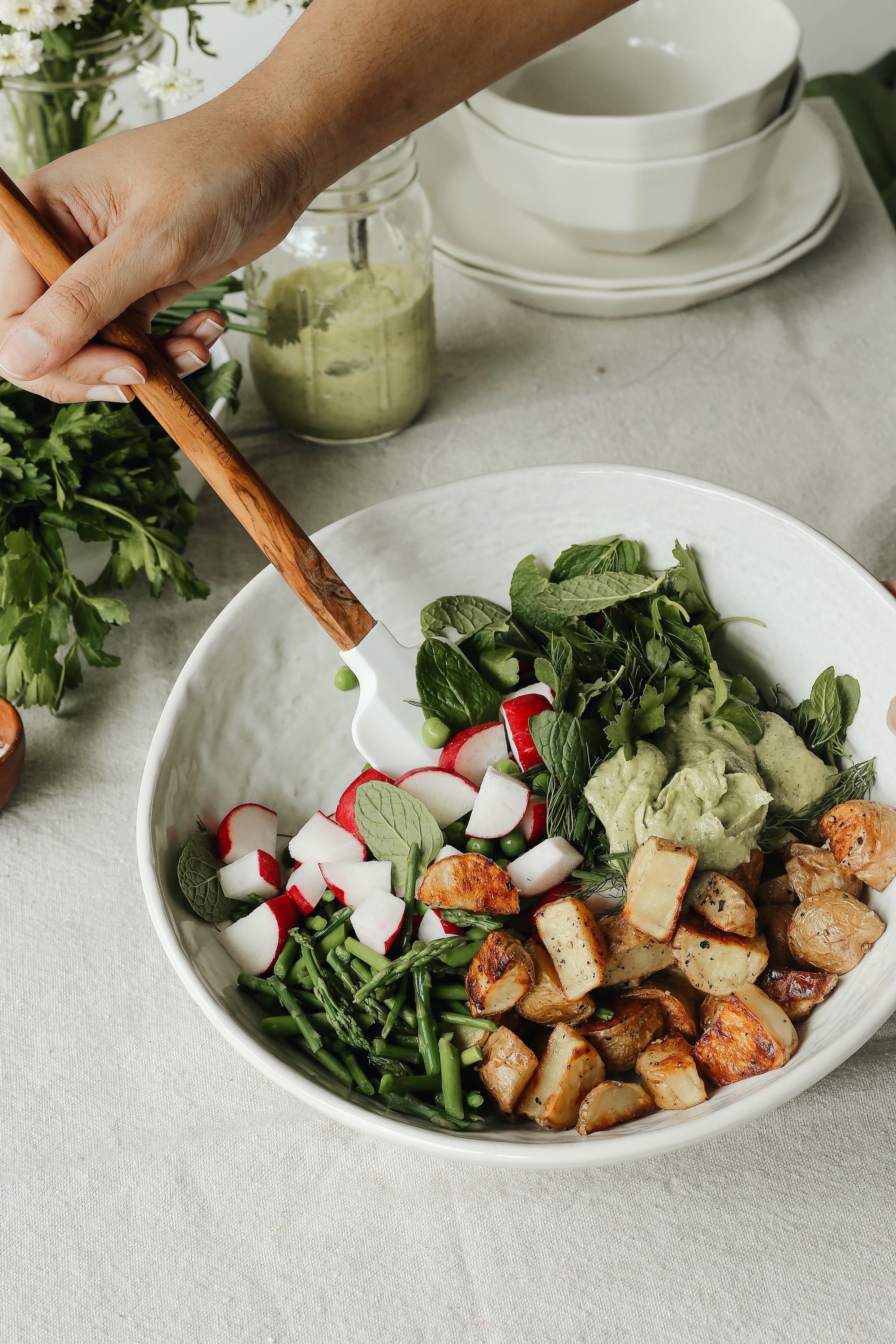 spring herbs and roasted potato salad with tahini green goddess dressing