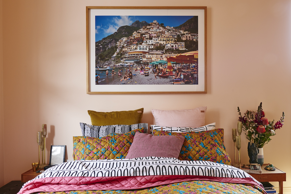 colorful bedroom with pink walls and patterned bedding from kip&co