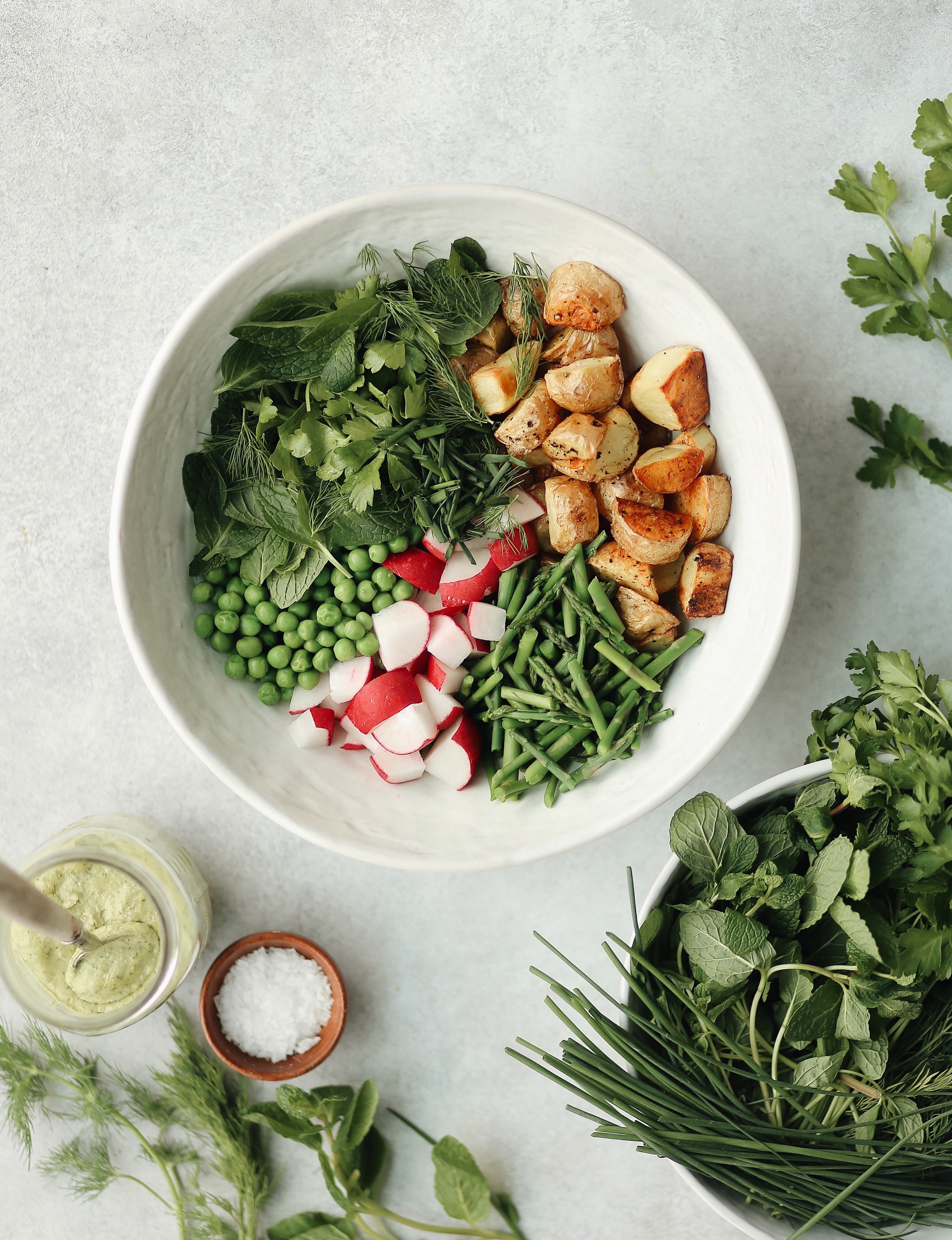 spring herbs and roasted potato salad with tahini green goddess dressing