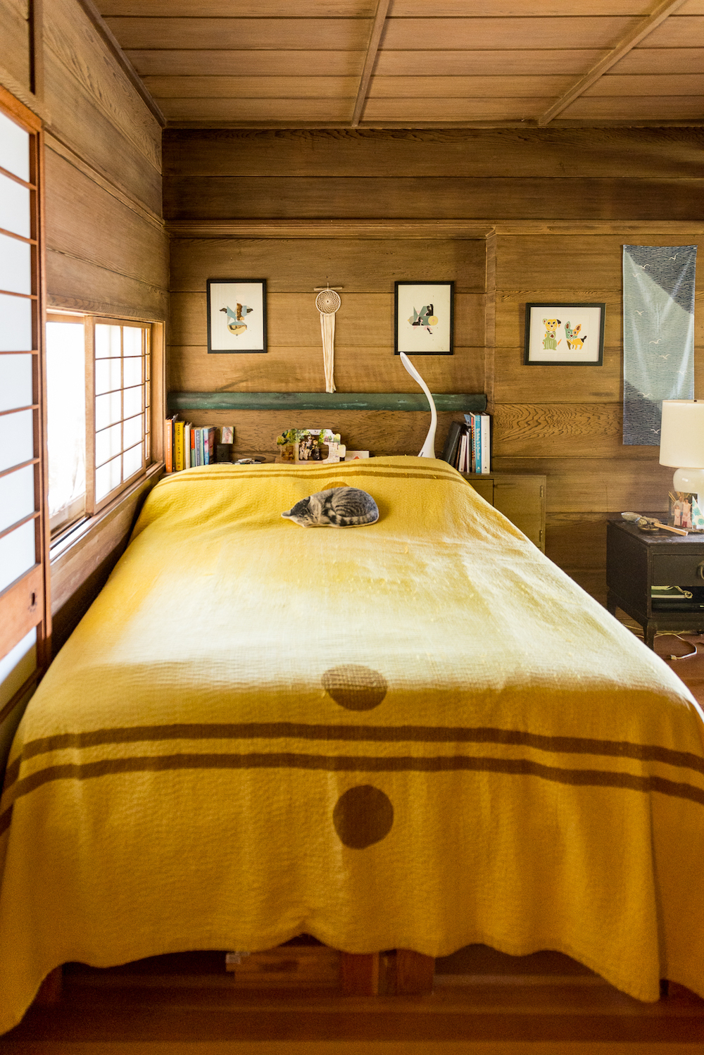 hippy minimalist bedroom with a yellow bedspread