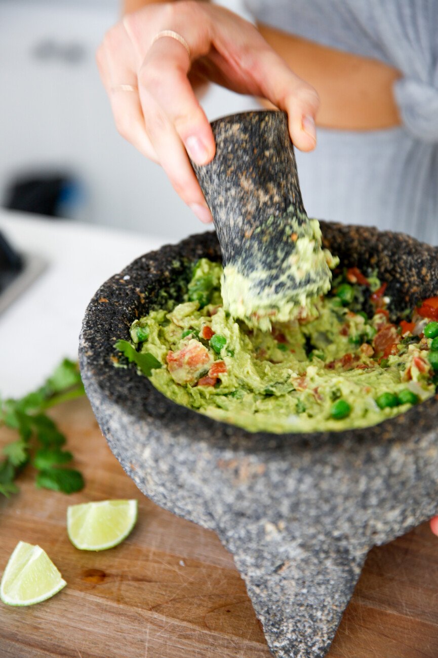 mixing green pea guacamole