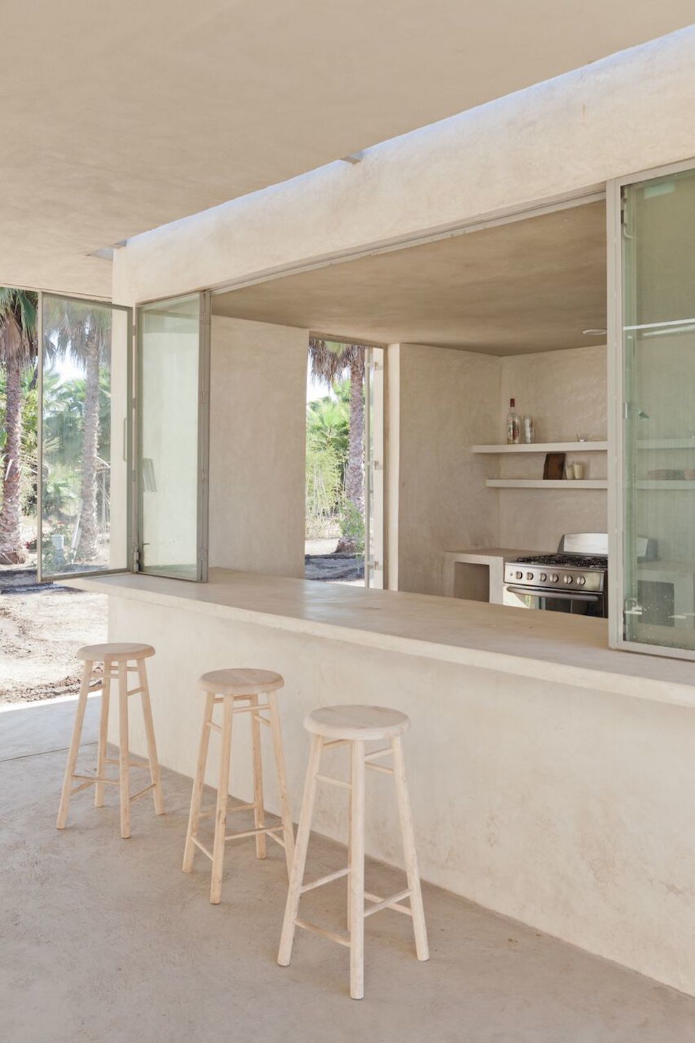 minimalist white outdoor kitchen made with stucco or plaster