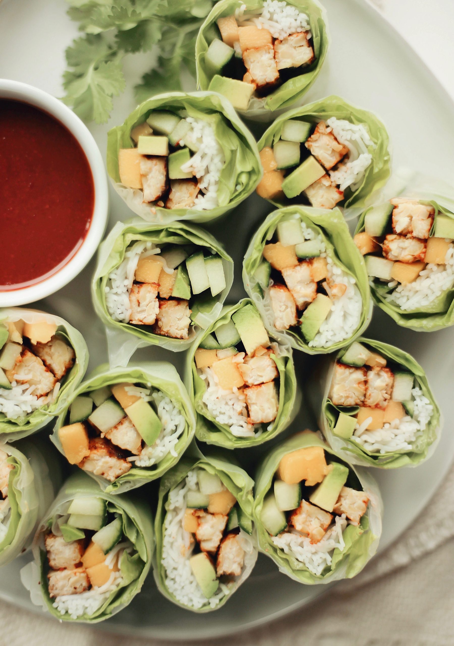 honey sriracha marinated tempeh rice noodle spring rolls with cucumber, mango, and avocado_workout foods