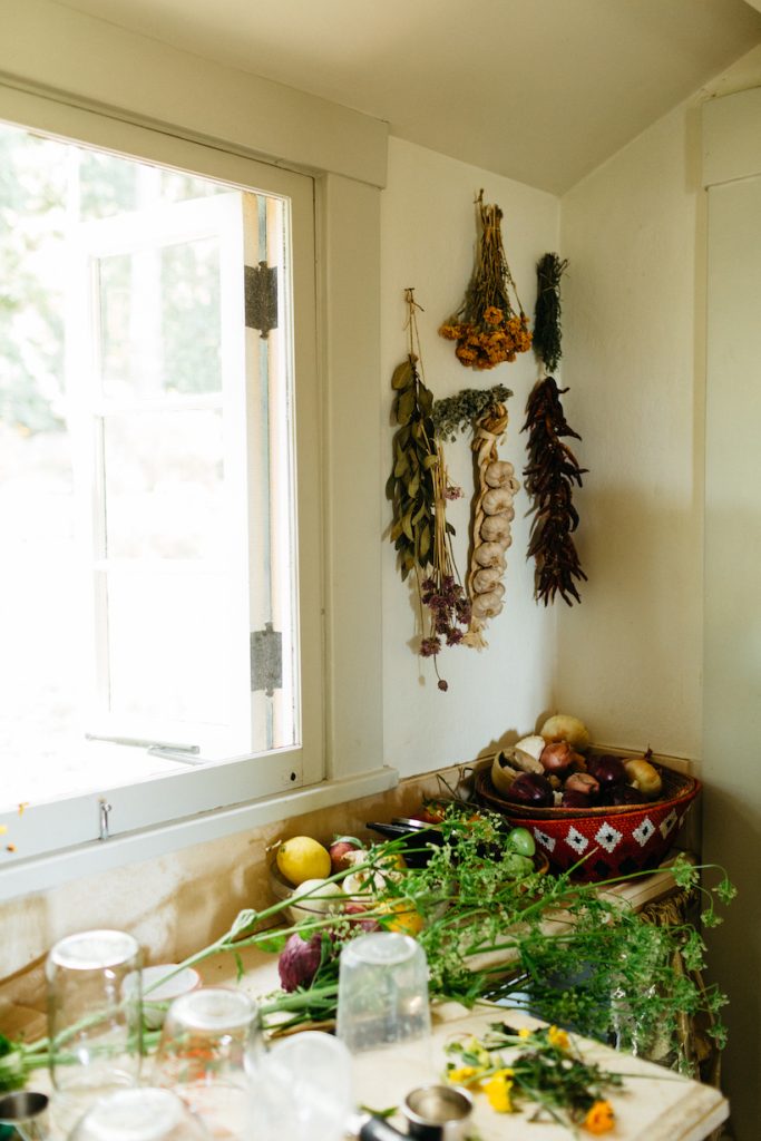 hanging garlic and dried herbs in loria stern kitchen