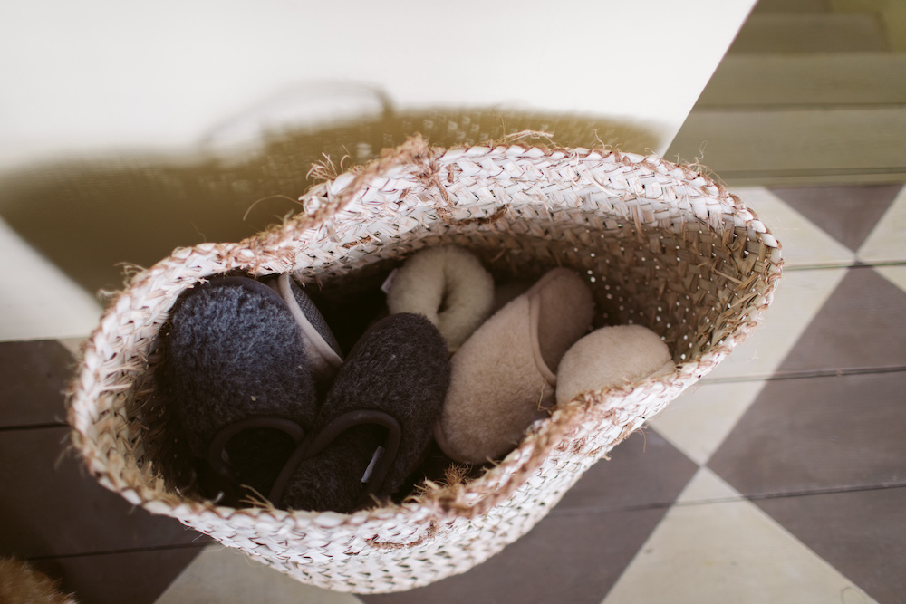 basket of slippers for guests who come over in the fall