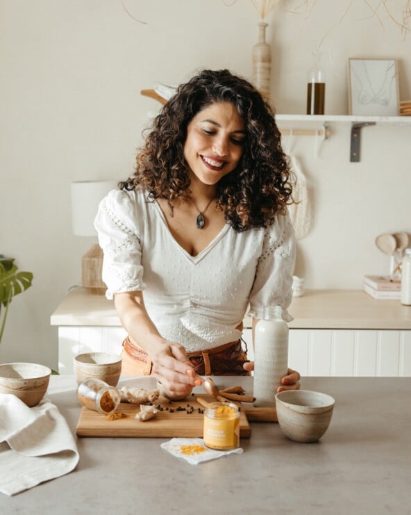 Woman making golden milk