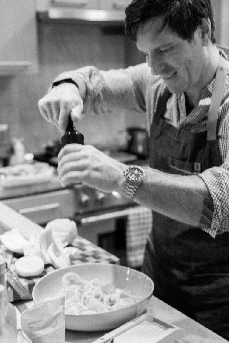 chef Seamus Mullen seasoning veggies in his kitchen