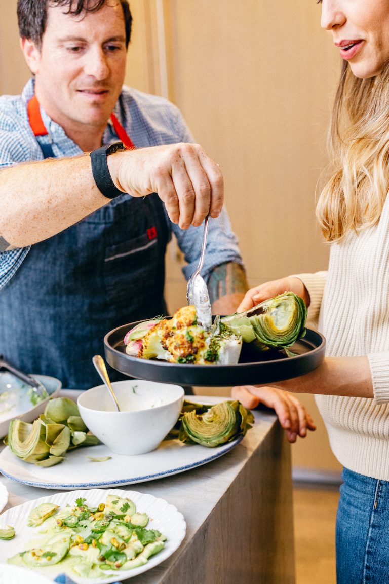 chef Seamus Mullen seasoning veggies in his kitchen