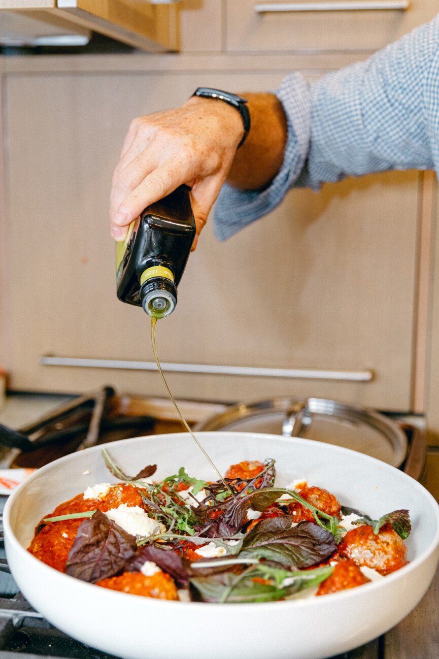 olive oil drizzle on spicy lamb meatballs