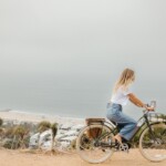 Woman riding bike outside.