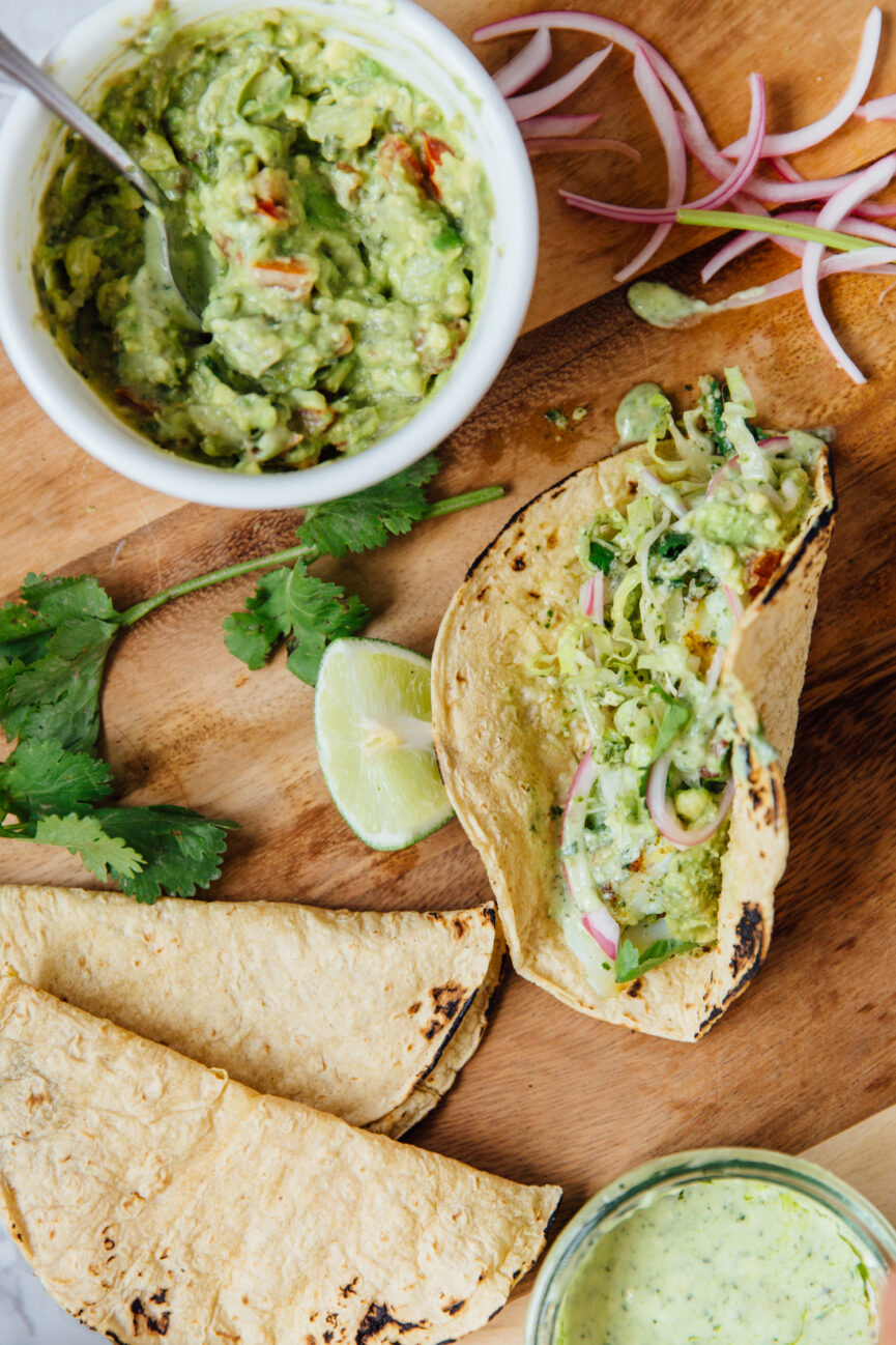 chimichurri fish tacos on wood serving board