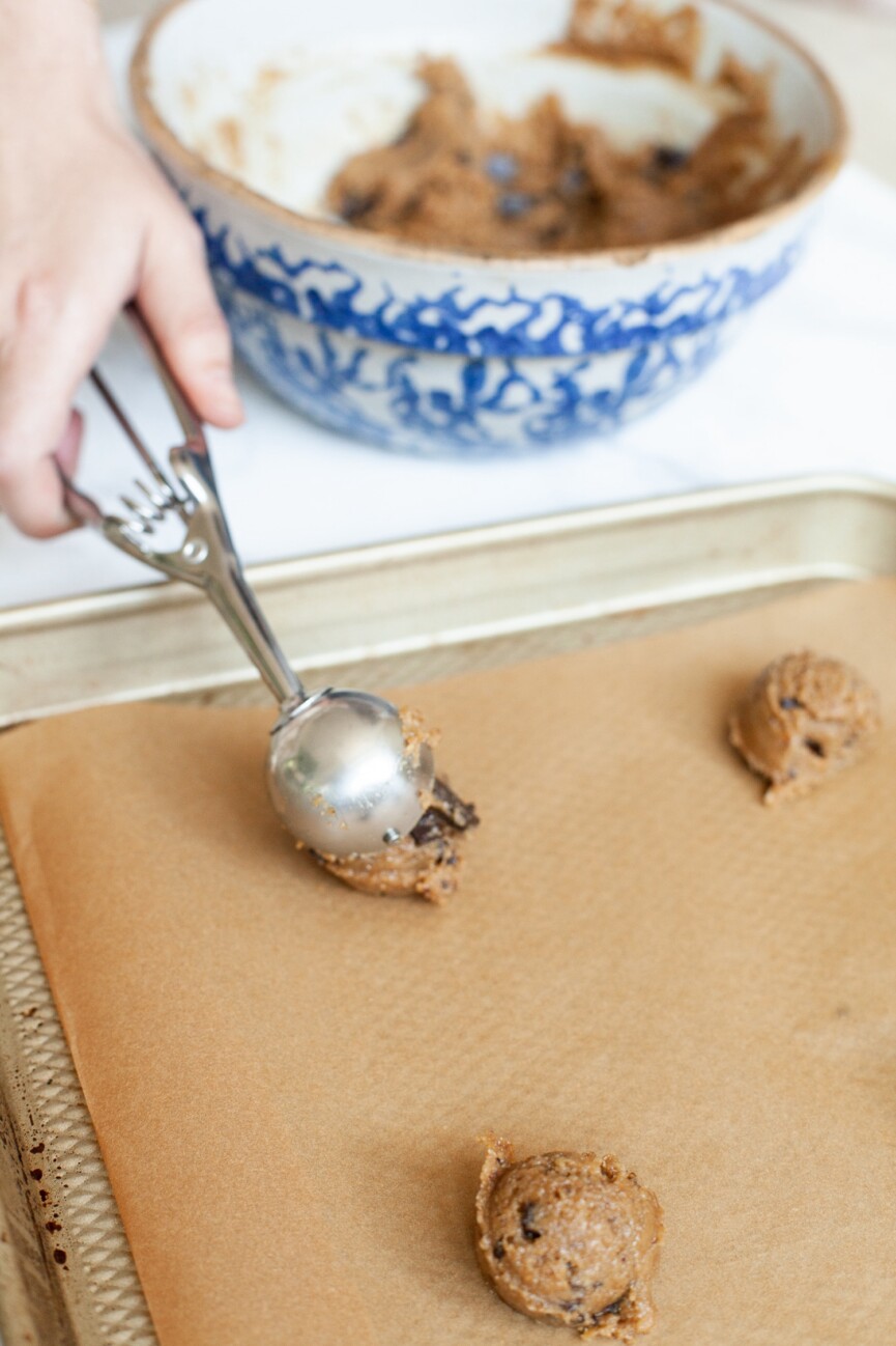 scooping gluten and dairy free chocolate chip cookies onto baking sheet