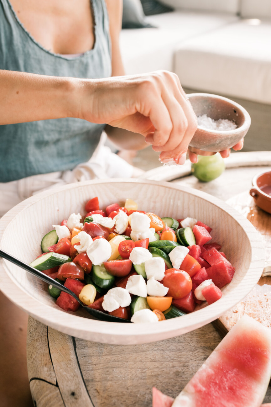 assembling watermelon tomato caprese salad