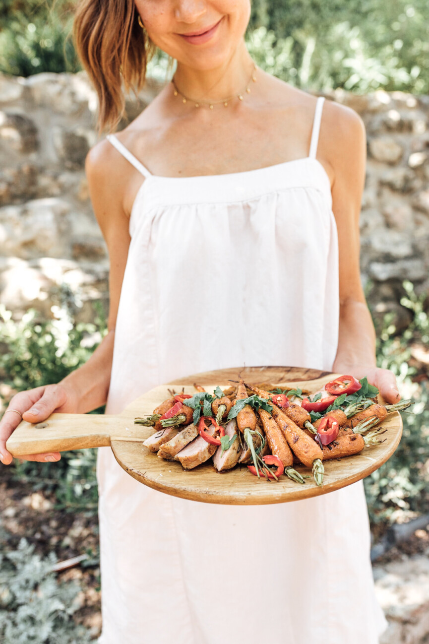 camille styles holding orange glazed pork tenderloin