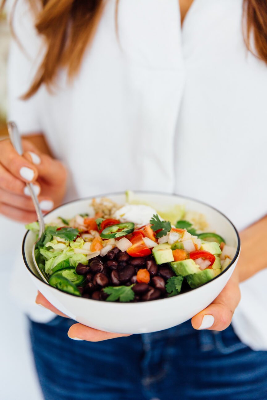camille styles holding slow cooker chicken burrito bowl