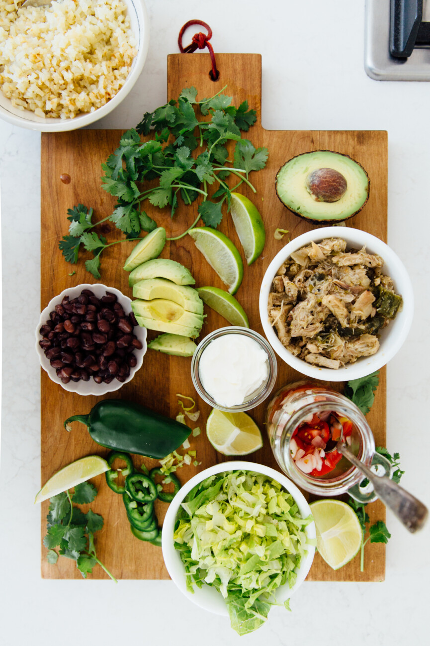 slow cooker burrito bowl ingredients on serving tray