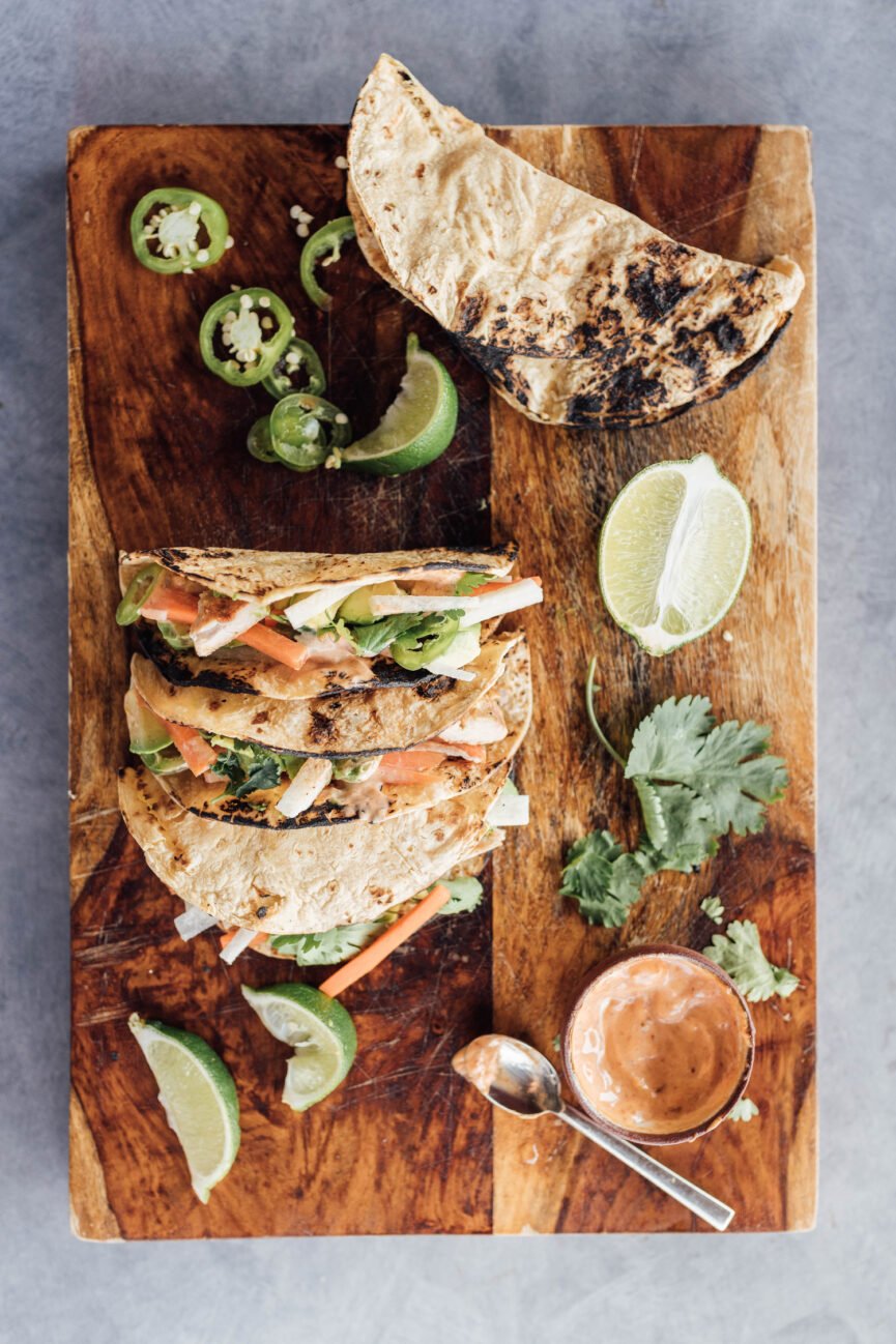 lime-y chicken tacos on wood serving board