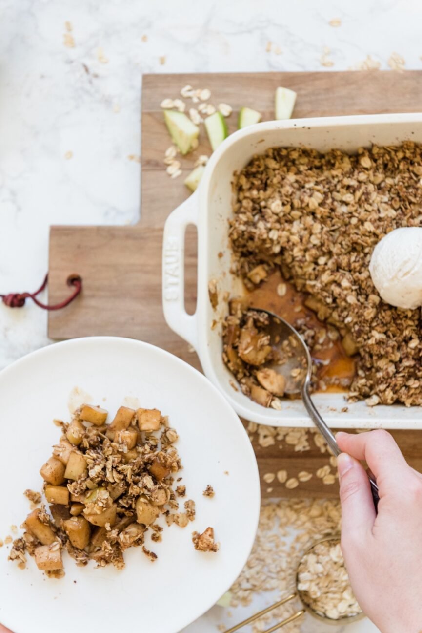 scooping apple crumble onto plate