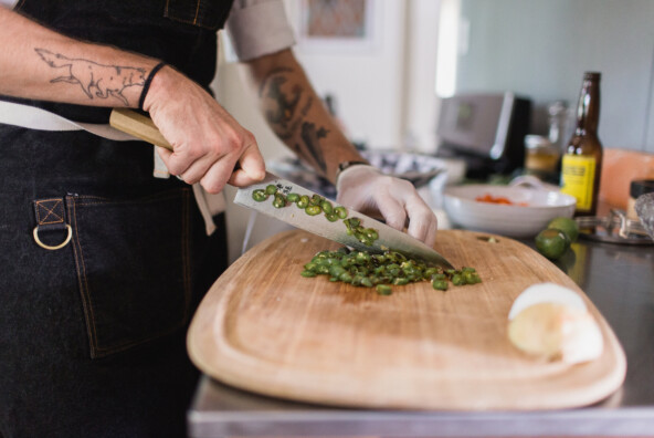 chef chopping with tattoo