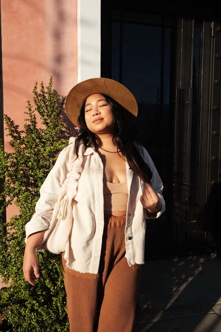 Kristin Corpuz standing in sunlight wearing hat_best sunscreens for reapplication