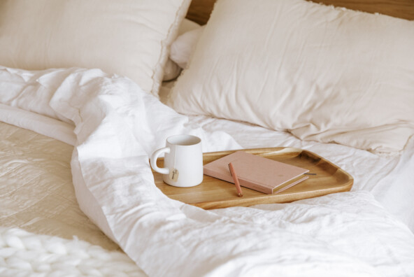journal and coffee in bed