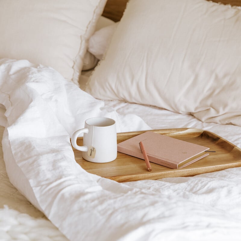 journal and coffee in bed